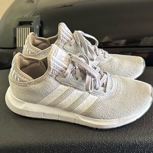 Grey and white Adidas tennis shoes